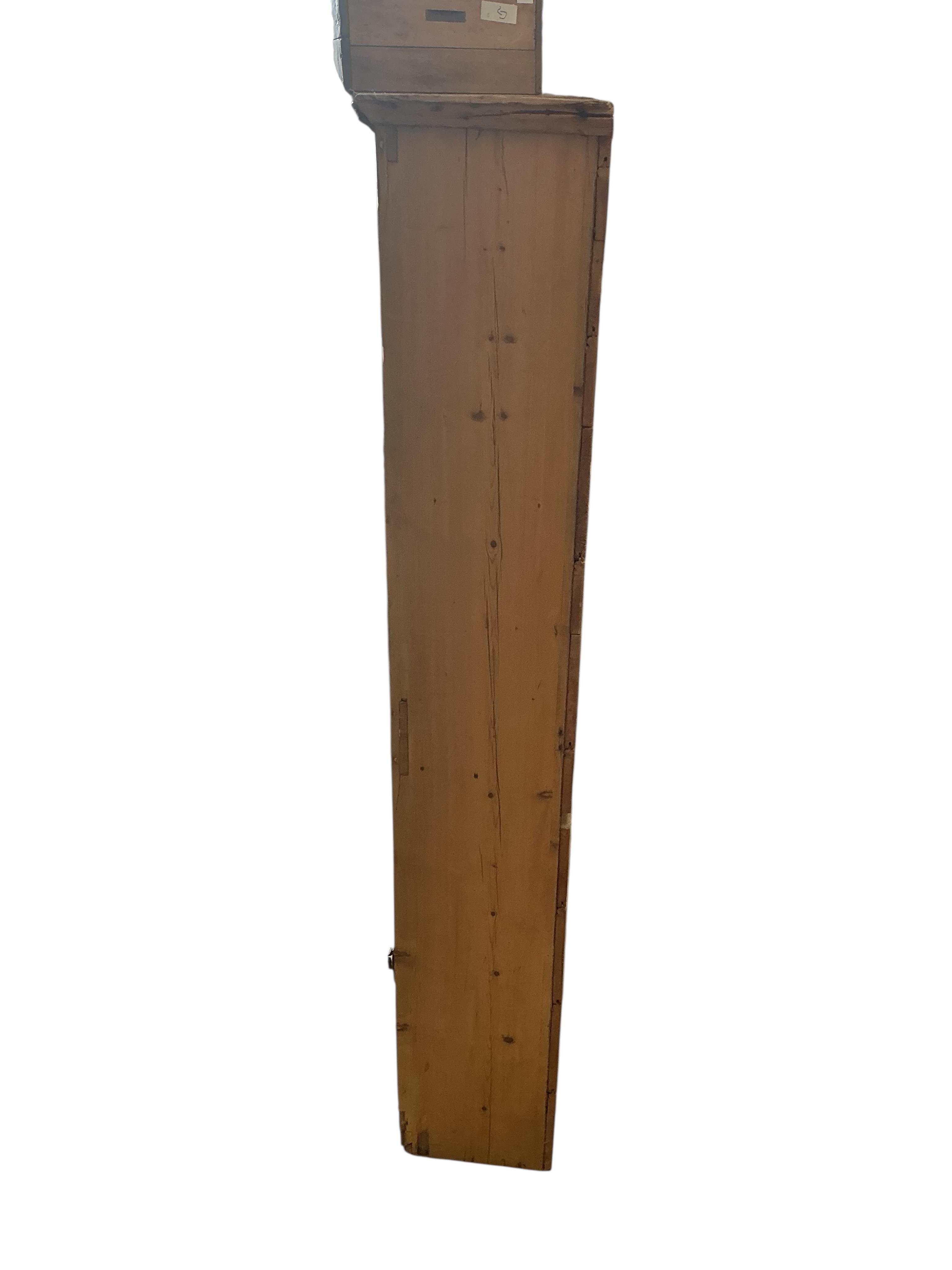A Victorian pine narrow two door cupboard, width 43cm, depth 26cm, height 148cm